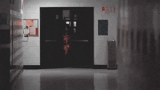a person is walking through a doorway in a hallway .