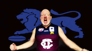 a man wearing a maroon jersey with the letter t on it