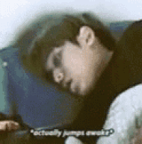 a man is sleeping on a couch and talking to someone .