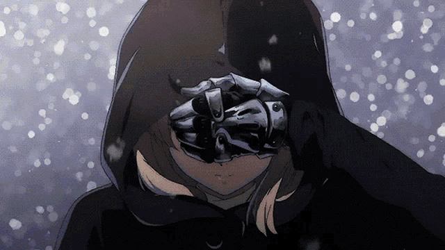 a person wearing a hood and gloves covering their face