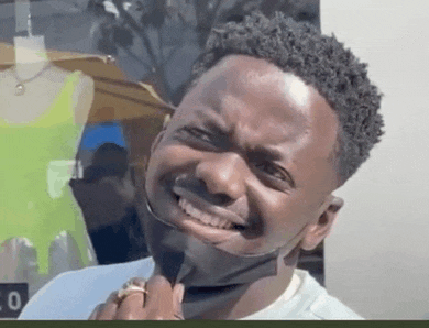 a man wearing a mask is making a funny face while holding a ring .