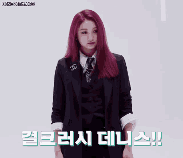 a woman with red hair is wearing a black suit and tie