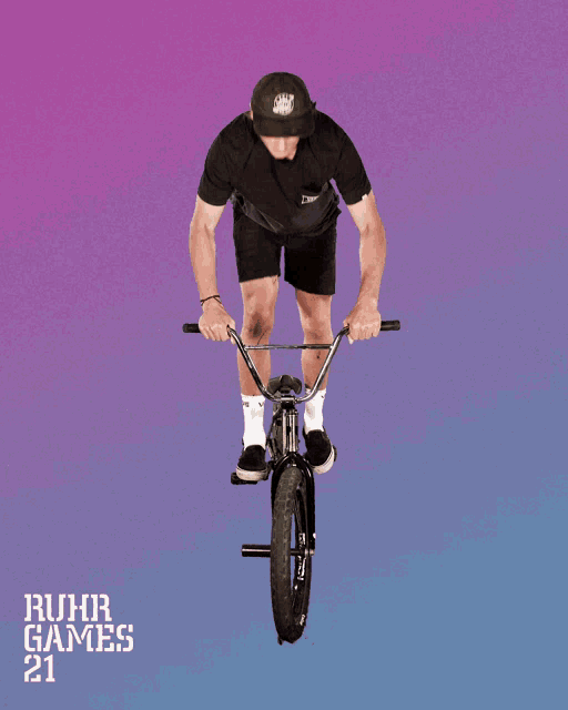 a man is riding a bike with the words ruhr games 21 on the bottom