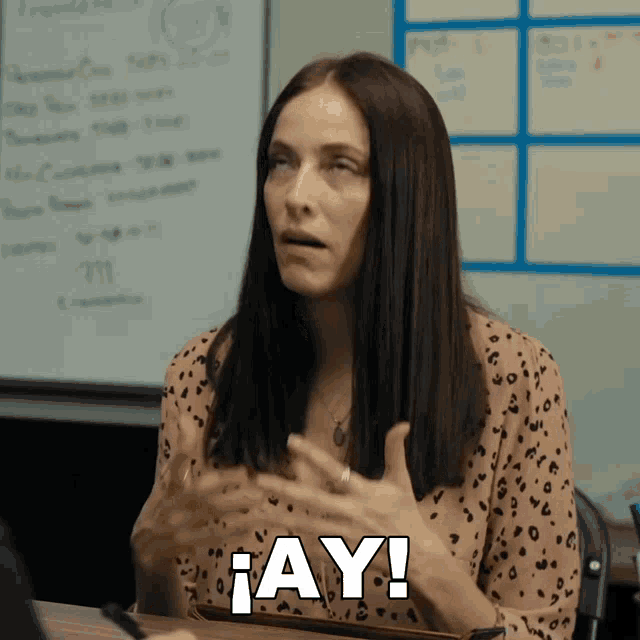 a woman in a leopard print shirt says " ay "