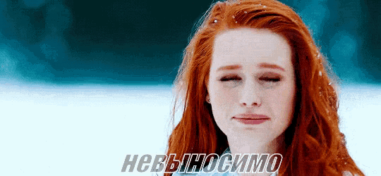a woman with red hair is crying in the snow