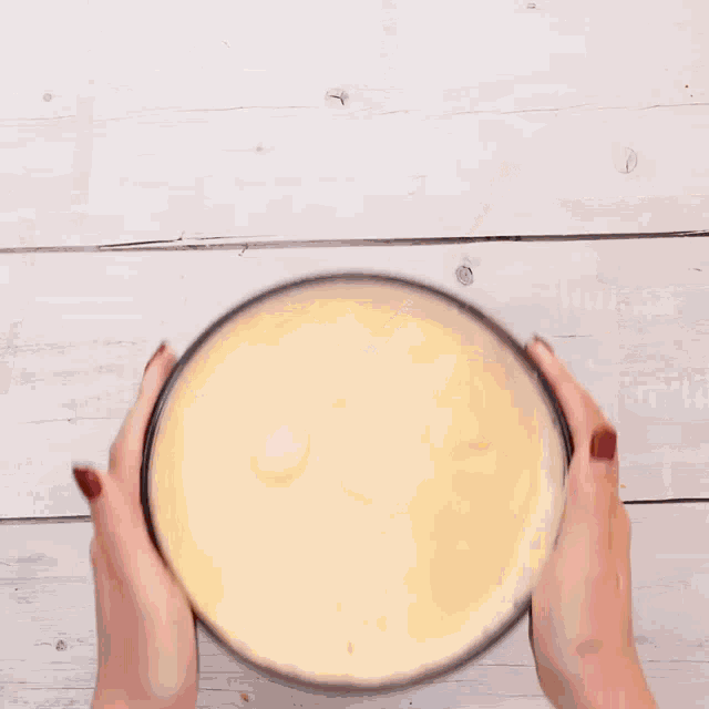 a slice of cheesecake is being poured into a paper bag
