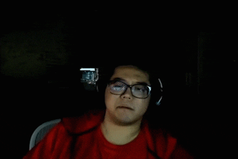 a man wearing glasses and headphones is making a funny face .