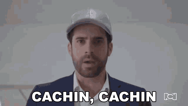 a man in a suit and hat is pointing at the camera and saying `` money , money '' .