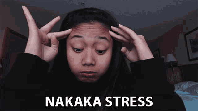 a woman with her hands on her head and the word nakaka stress written below her