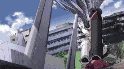 a robot is standing in front of a building in a city with a blue sky in the background .