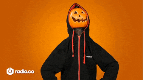 a person wearing a hoodie with a pumpkin head