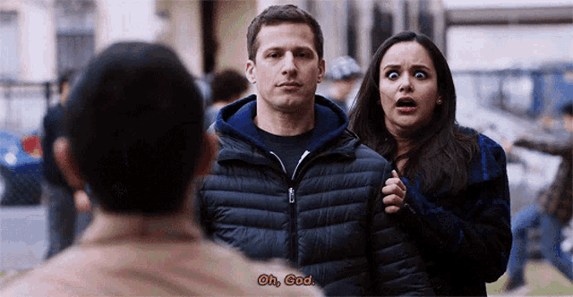 a man and a woman are standing next to each other and the man is saying oh god