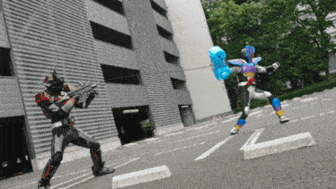 two robots are fighting in a parking lot and one has a blue balloon in his hand