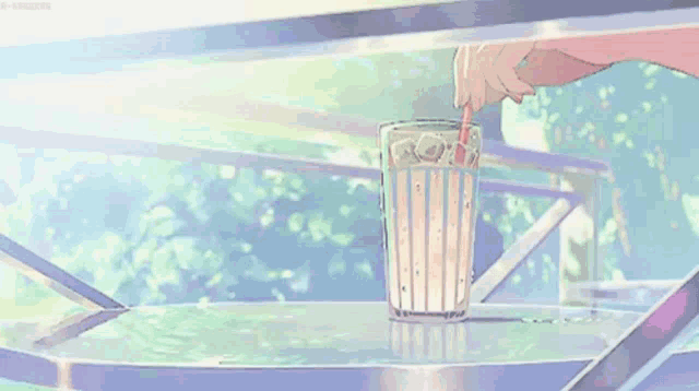 a person is pouring a drink into a glass with a straw and the word regrets written on it .
