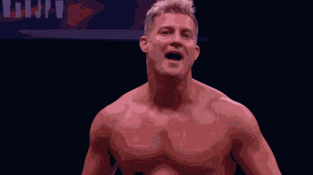 a shirtless man with his mouth open stands in front of a sign that says " njpw "