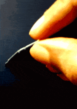 a close up of a person 's finger holding something