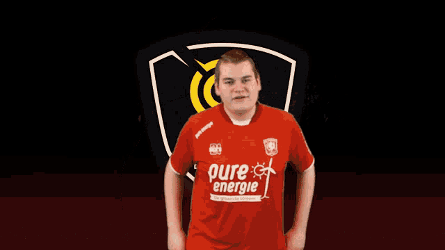 a man is wearing a red shirt that says pure energie on it