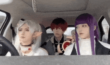 a group of people in cosplay are sitting in a car