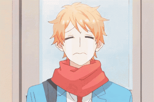 a man in a suit and scarf is crying