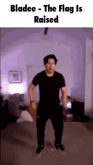 a man in a black shirt is dancing in a living room with the words bladee - the flag is raised above him