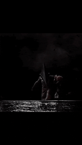 a person with a pyramid head is standing in a room
