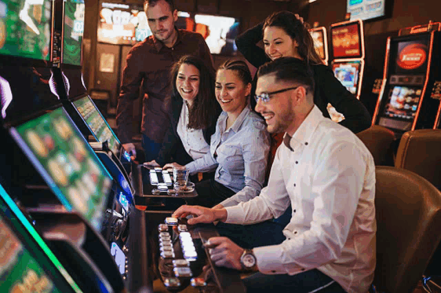 a group of people are playing slot machines in a casino and one of the machines has a red sticker that says ' vegas '