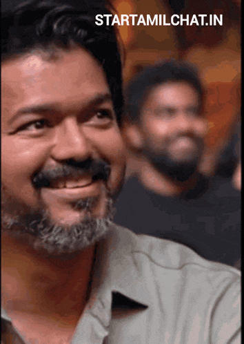 a man with a beard and mustache is smiling with the words starttamilchat.in above him