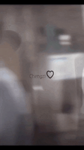 a blurry picture of a person with the name chengzi written on the glass