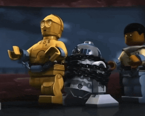 a lego r2d2 robot is chained to a c3po robot