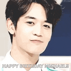 a close up of a young man 's face with the words `` happy birthday michael '' written next to him .
