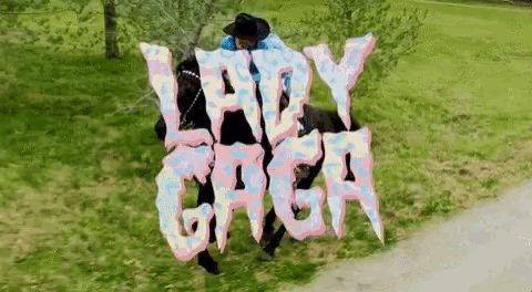 a person is riding a horse with the lady gaga logo on it