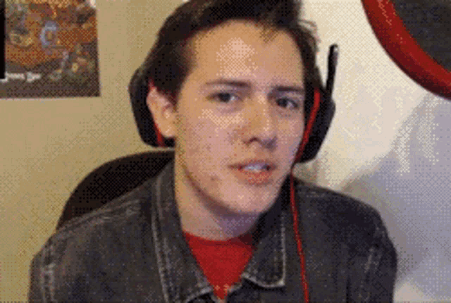 a man wearing headphones looks at the camera