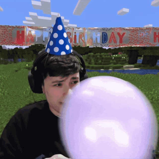 a man wearing a birthday hat blows up a purple balloon