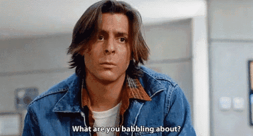 a man in a denim jacket is talking to another man and asking what are you babbling about .