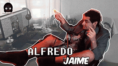 alfredo jaime is sitting in front of a computer holding a remote control