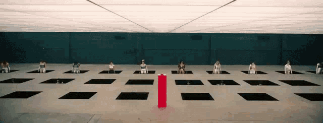 a group of people sitting in squares in a large room