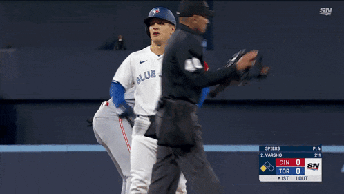 a baseball player for the blue jays is being chased by an umpire