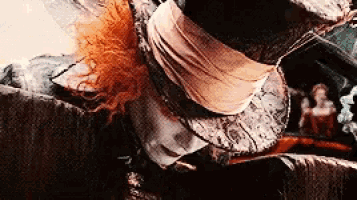 a close up of a hat with a feather on it