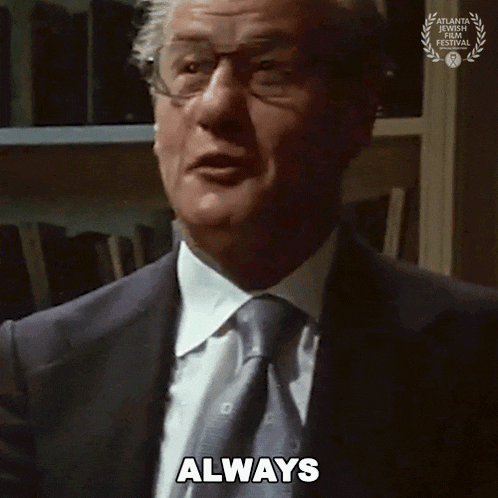 a man wearing glasses and a suit says always