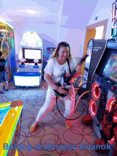 a woman playing a video game with the words boldog szulnapot kivanok written below her