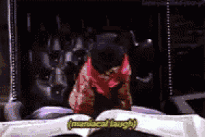 a man in a red scarf is sitting in a chair with the words maniacal laugh below him .