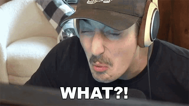 a man wearing headphones and a hat says what on the screen