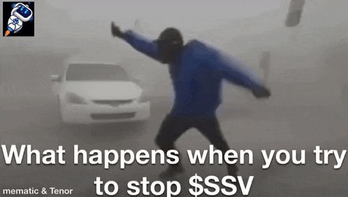 a man in a blue jacket is standing in front of a white car in the fog .