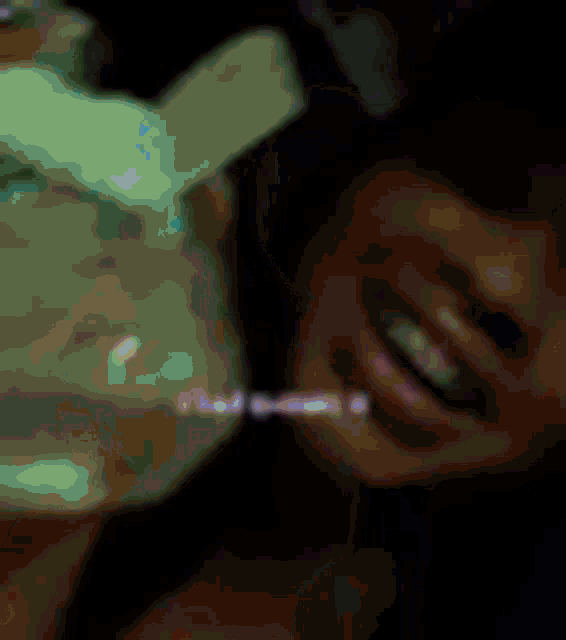 a close up of a person 's face with a blurred background .