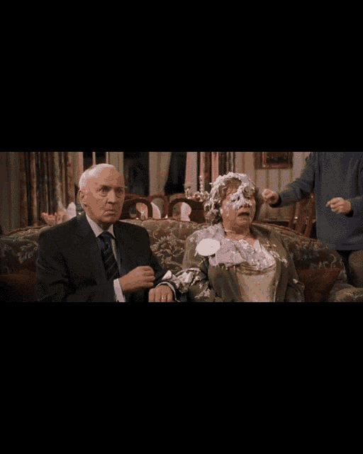 a man and woman are sitting on a couch and the man says i 'm so sorry it 's my nephew