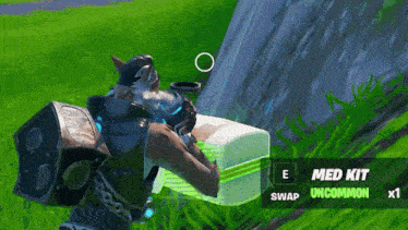 a person in a video game is holding a box that says med kit on it