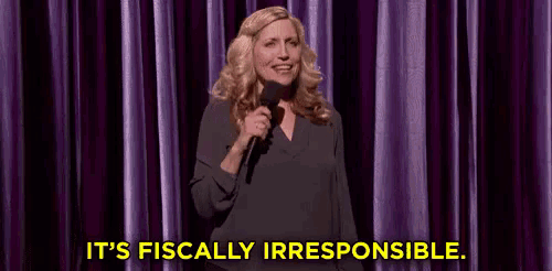 a woman is holding a microphone on a stage and saying `` it 's fiscally irresponsible '' .