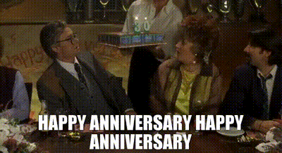 a group of people are sitting at a table with the words happy anniversary happy anniversary written on the bottom