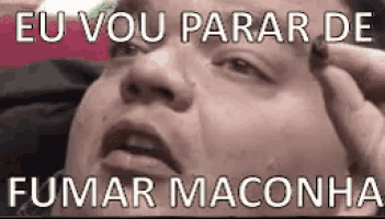 a close up of a person 's face with the words `` eu vou parar de fumar maconha '' written on it .