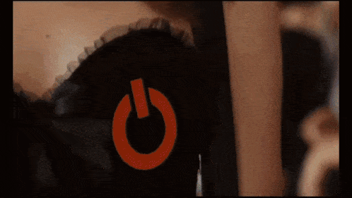 a close up of a woman 's chest with a red power button